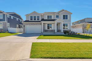 View of front of home featuring a garage and a front lawn