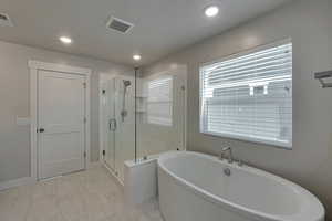 Bathroom featuring shower with separate bathtub