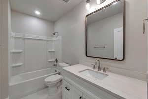 Full bathroom featuring shower / bathtub combination, vanity, and toilet