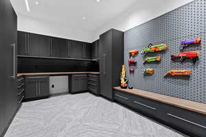 Interior space with modern cabinets, light countertops, and dark cabinets