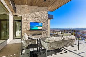 View of patio with an outdoor living space with a fireplace