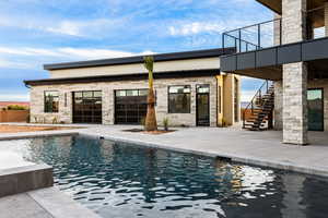 Pool featuring a patio area and stairway