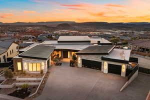 Contemporary house featuring a garage, concrete driveway, and a mountain view