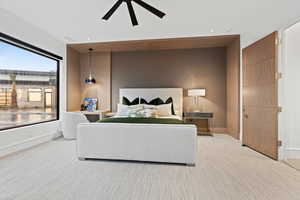 Bedroom with light carpet, baseboards, and a ceiling fan