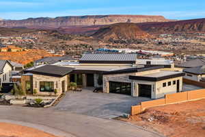 View of front of property with a mountain view, driveway, and an attached garage