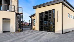 View of property exterior featuring stairway and stucco siding