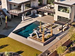 Pool featuring an outdoor kitchen, a pergola, and a patio