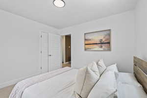 Carpeted bedroom featuring a closet