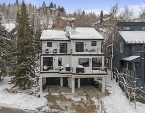 Snow covered house featuring a balcony