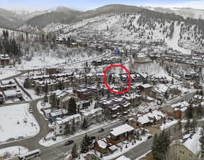 Snowy aerial view featuring a mountain view