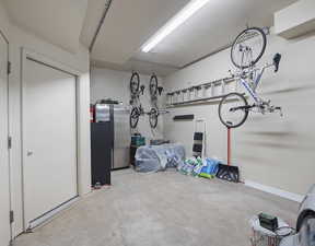 Garage featuring stainless steel refrigerator