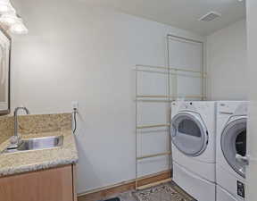 Laundry room featuring washer and dryer and sink