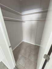 Spacious closet featuring light tile patterned flooring