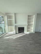 Unfurnished living room with built in features