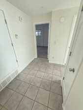 Empty room featuring light tile patterned floors