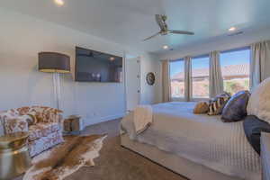 Carpeted bedroom with ceiling fan