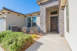 View of exterior entry featuring a patio