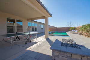 View of swimming pool featuring an in ground hot tub and a patio