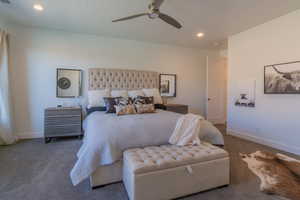 Carpeted bedroom featuring ceiling fan