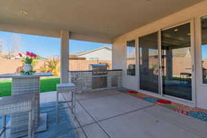 View of patio featuring area for grilling and grilling area