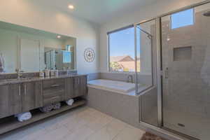 Bathroom featuring vanity and plus walk in shower