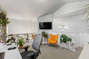 Office area with lofted ceiling, carpet, and ceiling fan