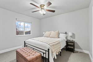 Bedroom featuring ceiling fan and carpet flooring