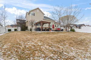 Back of property featuring a yard, a pergola, and a patio area