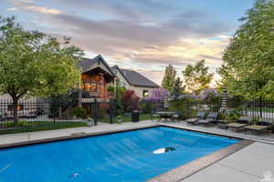 Pool at dusk with a patio