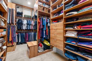 Spacious closet with light colored carpet