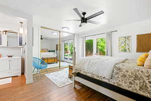 Bedroom with access to exterior, wood-type flooring, sink, and ceiling fan