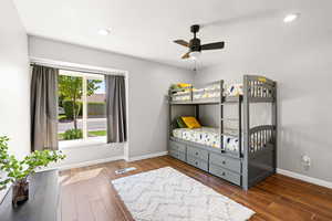 Bedroom featuring dark wood-type flooring and ceiling fan