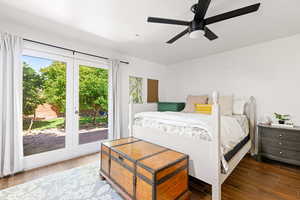 Bedroom featuring dark wood-type flooring, ceiling fan, and access to exterior