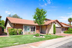 Ranch-style house with a garage and a front yard