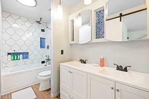 Full bathroom with shower / washtub combination, vanity, and toilet