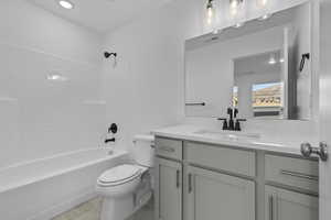 Full bathroom featuring shower / washtub combination, vanity, and toilet