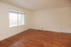 Unfurnished room featuring dark hardwood / wood-style floors