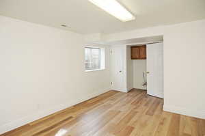 Unfurnished room with light wood-type flooring