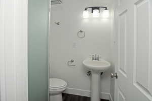 Bathroom featuring sink, wood-type flooring, and toilet