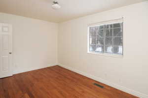 Unfurnished room with hardwood / wood-style flooring