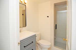 Bathroom featuring vanity, a shower, and toilet