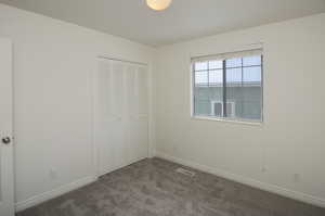 Unfurnished bedroom featuring carpet floors and a closet