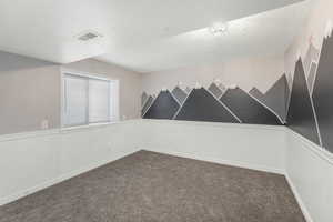 Bedroom with carpet and a textured ceiling