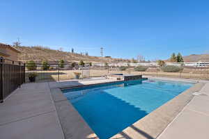 View of swimming pool featuring a mountain view and a patio area