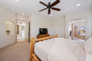 Bedroom with light carpet and ceiling fan