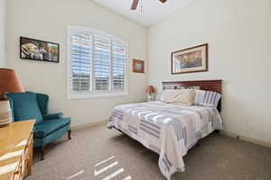 Carpeted bedroom with ceiling fan