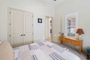 Carpeted bedroom featuring a closet