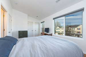 Bedroom featuring lofted ceiling