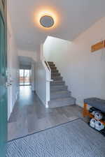 Staircase featuring hardwood / wood-style floors