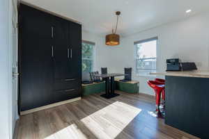 Office space with plenty of natural light and light hardwood / wood-style floors